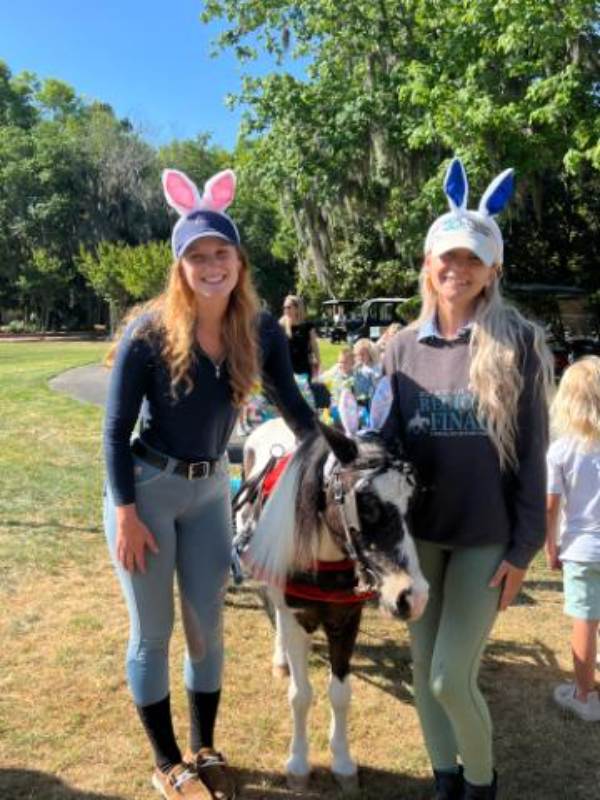 Two women with pony wearing bunny ears
